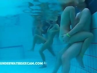 Witness these nasty teenie honeys enjoyment each other in a public pool, no shame!